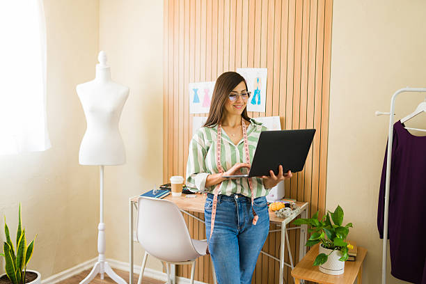 istock Dress designer working on laptop in her studio 2214953976