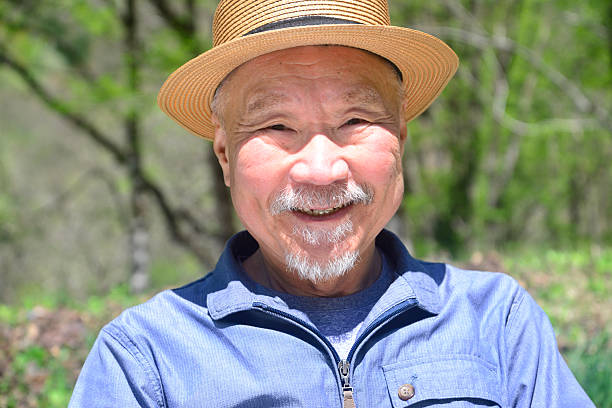 istock Smiling bearded old man enjoying forest bathing 2214958999