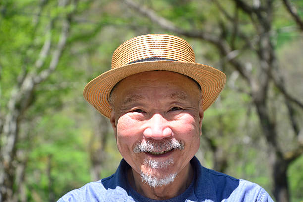 istock Smiling bearded old man enjoying forest bathing 2214959003