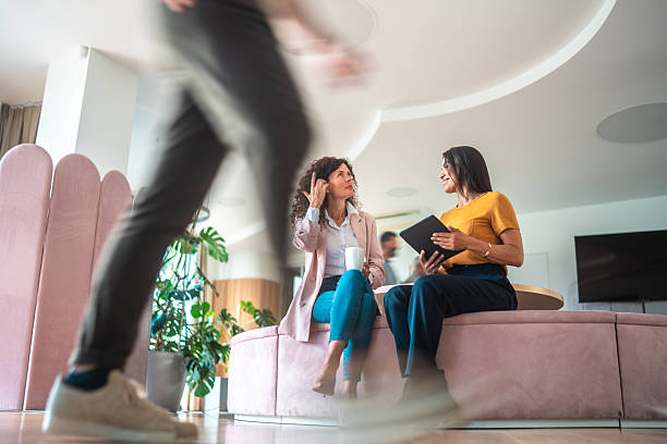 Caucasian and Hispanic Women Collaborating in Office Environment