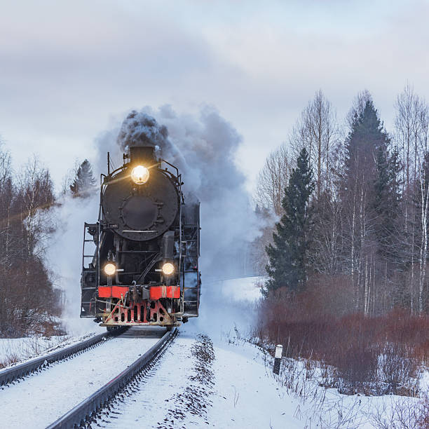 istock Retro steam train arrives at winter. 2214959053