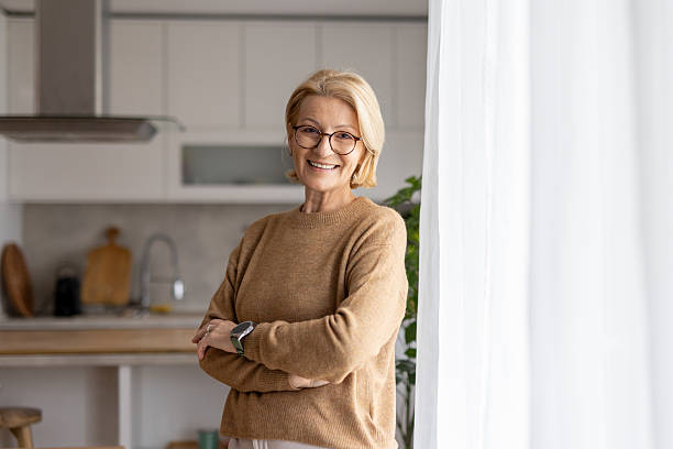 istock Cheerful woman posing in a sunlit kitchen area 2214959356