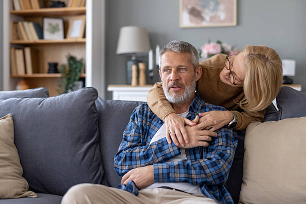 istock Couple sharing a cozy moment on the couch together smiling 2214959365
