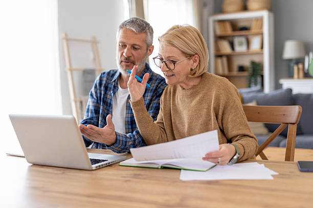 istock Couple Discussing Ideas While Working on Their Laptop 2214959371