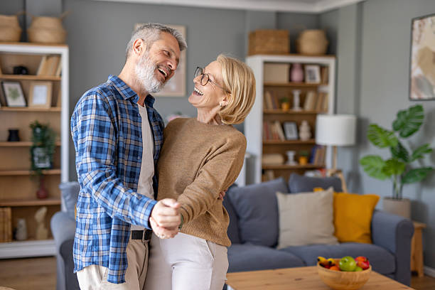 istock Couple dancing joyfully in their cozy living room. 2214959379
