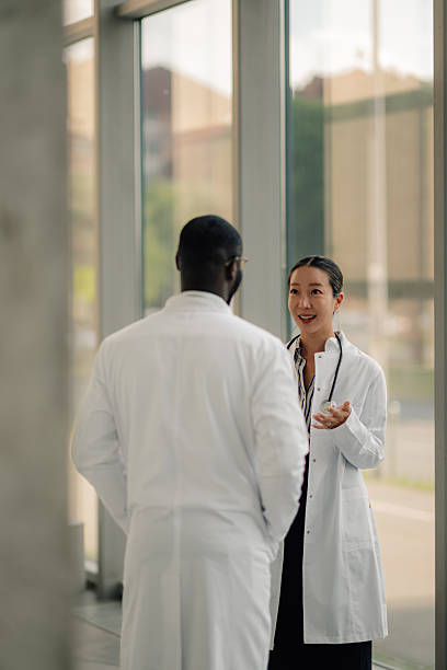 istock Doctors discussing patient care in hospital corridor 2214960628
