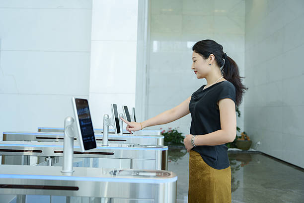 istock Asian woman using facial recognition security door in lobby 2214964981
