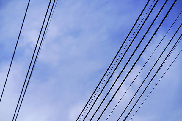 Electric transformers and power lines against the sky.