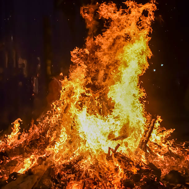 istock Fire flames on black background, Blaze fire flame texture background, Beautifully, the fire is burning, Fire flames with wood and cow dung bonfire 2214971306