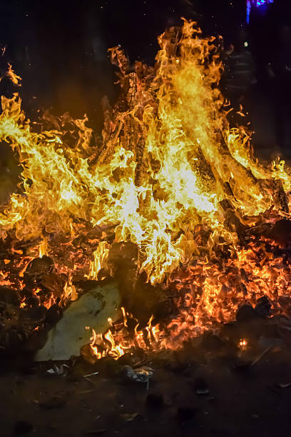 istock Fire flames on black background, Blaze fire flame texture background, Beautifully, the fire is burning, Fire flames with wood and cow dung bonfire 2214971313