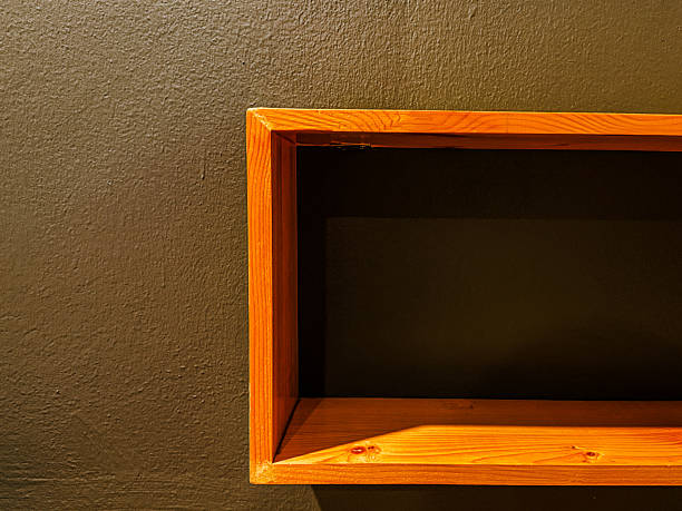 Brown wooden frame on black wall