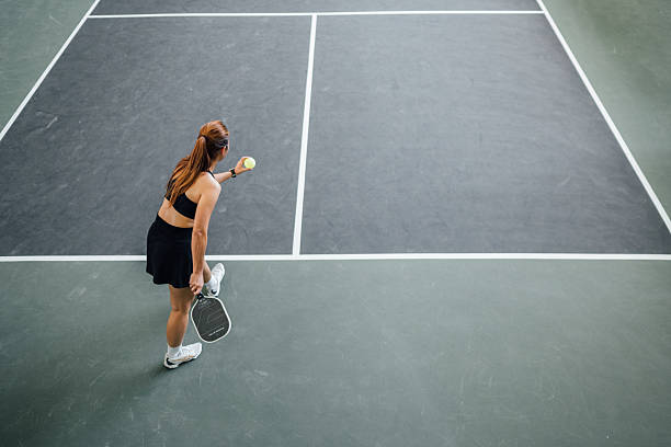 istock Capturing the Moment: Precision and Power in a Pickleball Serve Under the Open Sky 2214974056
