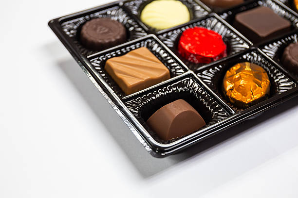 istock Chocolates in various shapes in beautiful premium packaging boxes on white background. Copy space background 2214974362