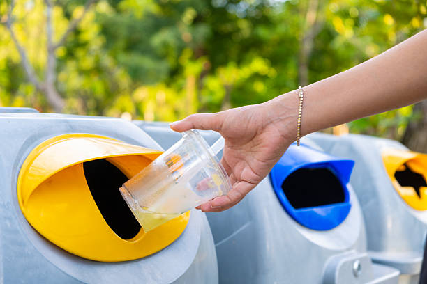 istock Please throw plastic bottles in the bin. Man littering the bins by separating waste for disposal such as recyclable plastic waste. environmental concept 2214975619