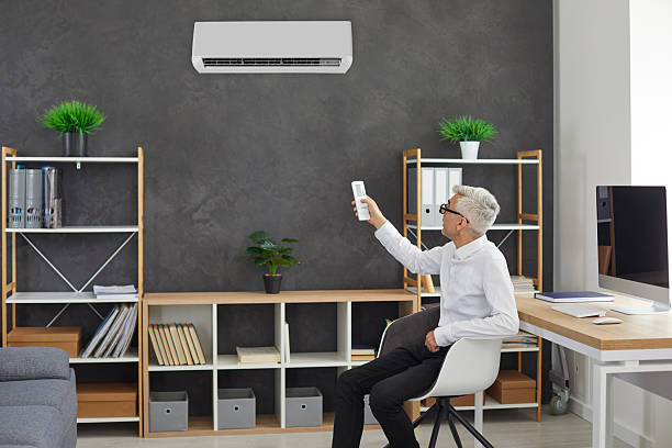 istock Man turn air conditioner for fresh ventilated air 2214979618