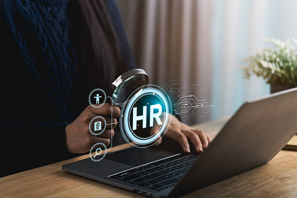istock Close-up hand woman analyzes HR data using a laptop and magnifying glass in a modern office, showcasing the integration of technology in human resources management and employee evaluation. 2214980349