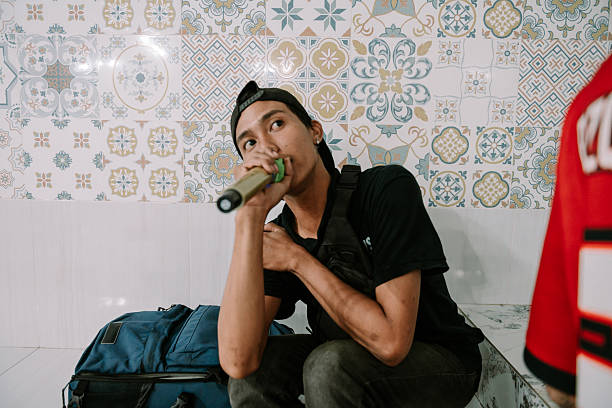 Passionate asian rapper with microphone performing urban musical art
