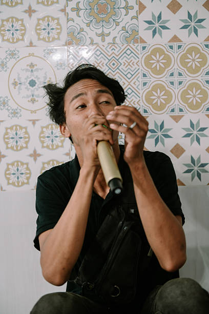 istock Expressive Young Man Performing Vocals Live with Microphone 2214981819