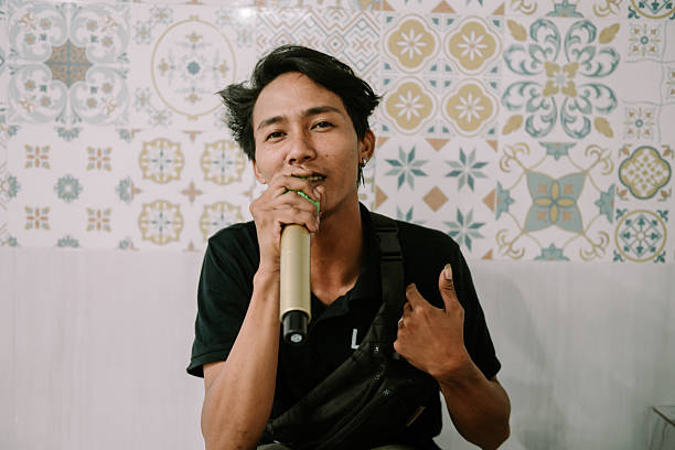 istock Enthusiastic young singer performing holding microphone indoors 2214981842