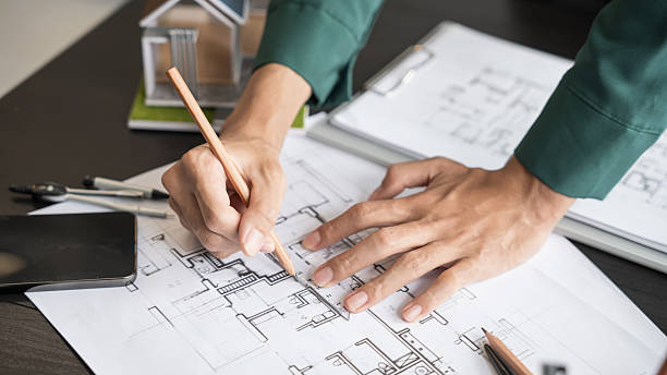 istock Architecture Man drawing on architectural Creative project business architecture building constructionÂ Industrial engineering Achievement Planning Design on eco blueprint 2214984471