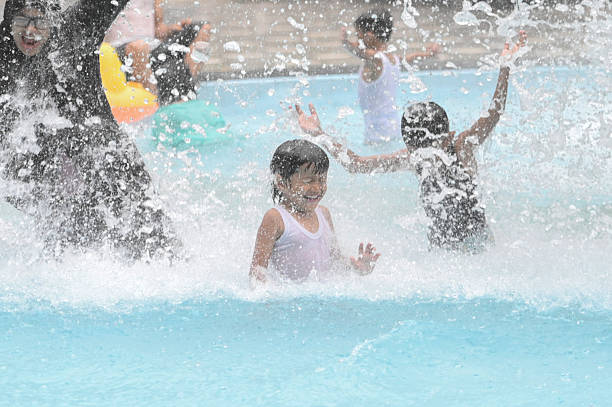 Mother and son having fun in the swimming pool