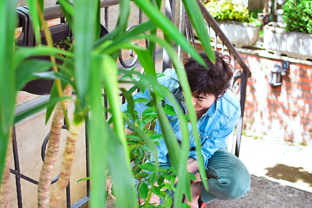 istock a middle-aged woman enjoys her plants 2214988673