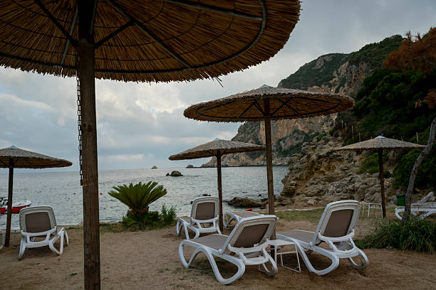 Sun beds and parasol on the beach of Neoi Epivates tourist resort of Thessaloniki in northern Greece