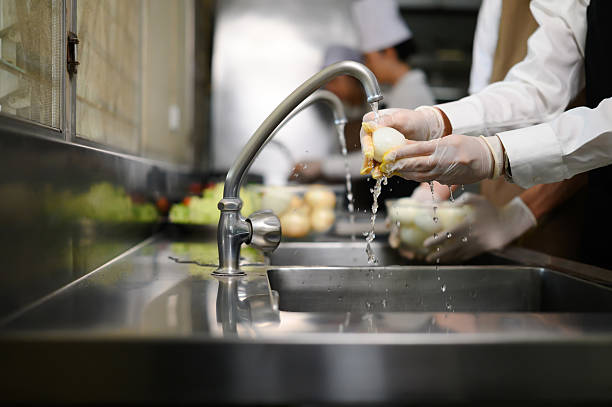 istock Smiling young chefs learning kitchen hygiene and teamwork in a professional cooking school 2214989514