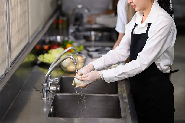 istock Smiling young chefs learning kitchen hygiene and teamwork in a professional cooking school 2214989566