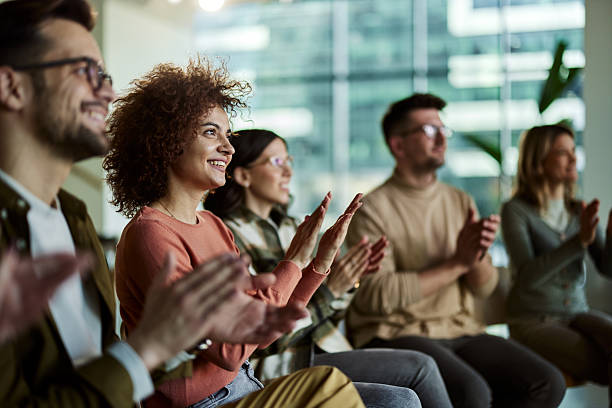 istock Happy entrepreneurs applauding on a seminar in board room. 2214989654