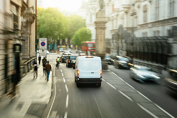 A delivery van in motion in a city street