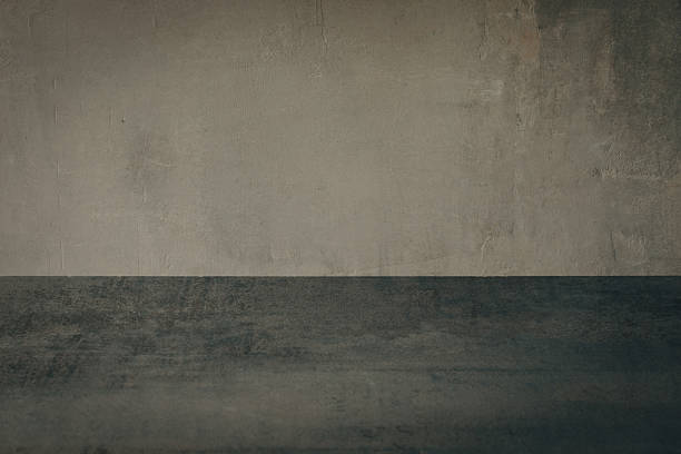 istock Beautiful gothic art background of roughly plastered wall and empty gray table surface, copy space. 2214990836