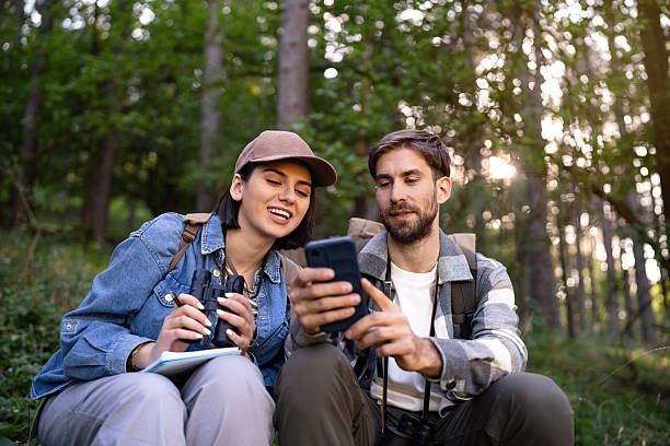 istock A young couple identifying bird species with a phone app while birdwatching in a peaceful forest setting 2214991117