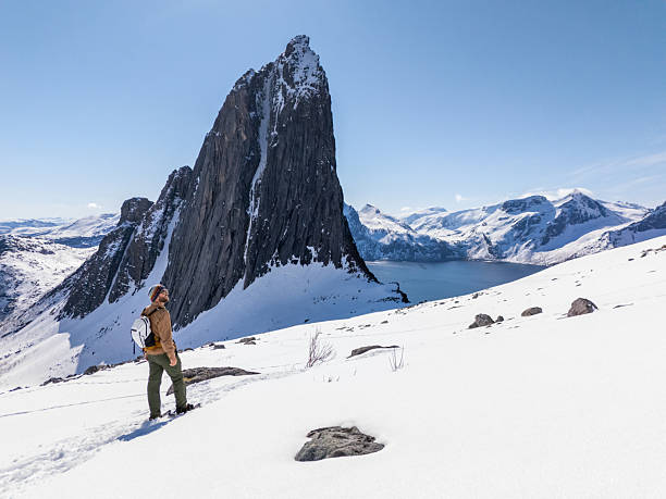 istock Hiker Admiring Snowy Mountain Landscape on a Clear Day 2214992343