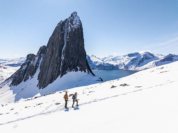 istock Hikers Trekking Through Snowy Mountain Landscape 2214992418