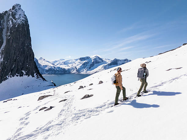 istock Hikers Trekking Through Snowy Mountain Landscape 2214992437