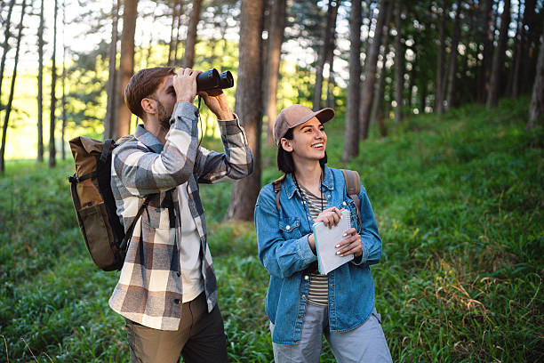 istock Two friends birdwatching together in a scenic forest environment 2214992541