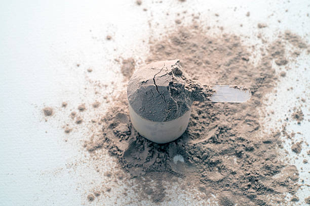 istock Scoop of Protein Powder on a Flat Surface with Spilled Powder 2214992790