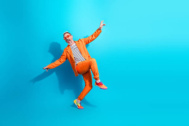 istock Charismatic and trendy middle aged man joyfully posing against vibrant blue background 2214994330