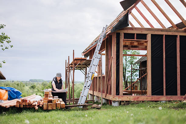 istock Professional engineer working at the wooden frame house construction site 2214995119