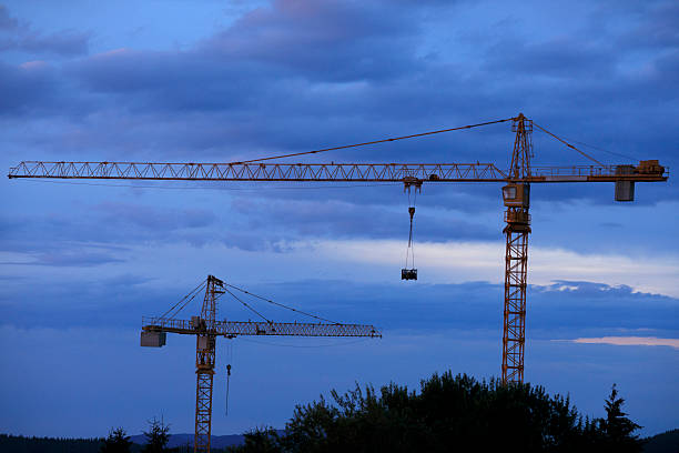 Cranes at construction site.  Building site at   view with colorful  vibrant cloud sky