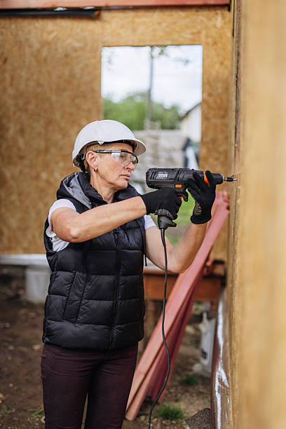 istock Determined Mature Woman Securing OSB Board at Construction Site - DIY Home Building Project 2214996851