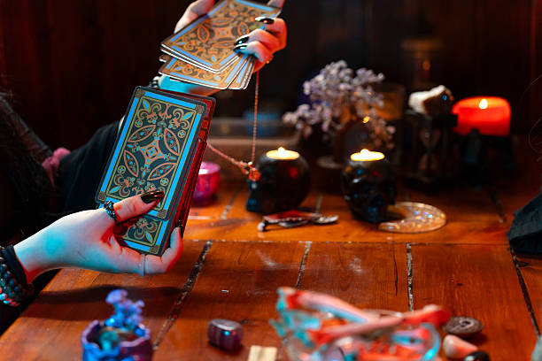 istock Fortune teller reading tarot cards predicting future during mystical session 2214997221