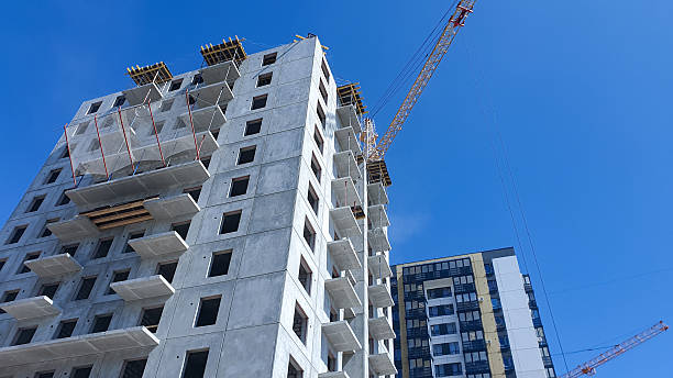 istock Construction crane against the background of a concrete slab house under construction. Construction of an apartment building. 2214997663