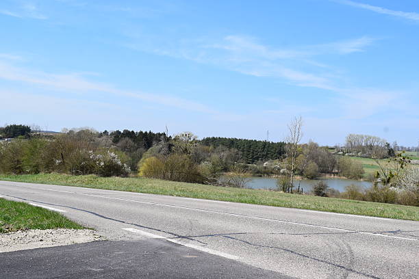istock country road along a lake 2214997744