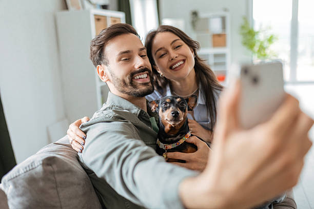 istock Happy Couple Snapping Selfie with Pet Dog 2214998138