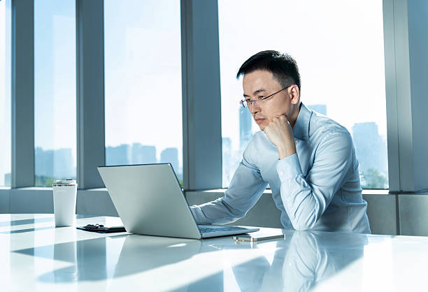 istock Businessman using laptop by the window 2215000316
