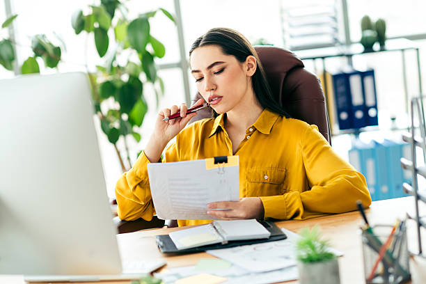 istock Professional businesswoman working at modern office desk while analyzing documents and planning 2215000331