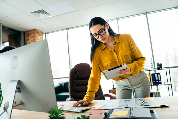 istock Young professional businesswoman working on a project in a modern office environment, showcasing teamwork and productivity 2215000379