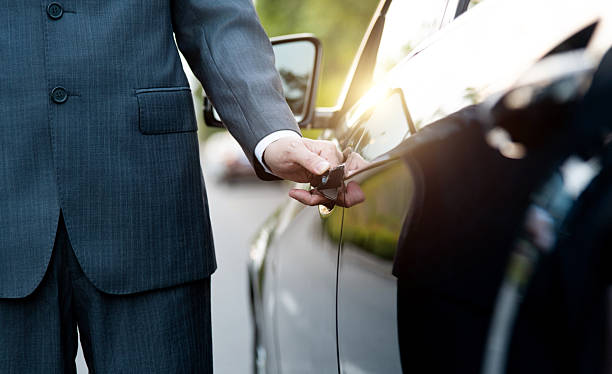 istock Well dressed man opening a car door 2215000443